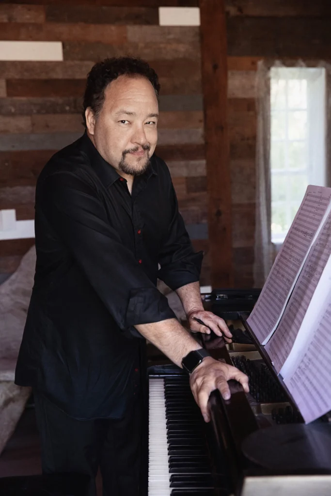 Robert Paterson standing at a piano. Credit: Lisa Marie Mazzucco