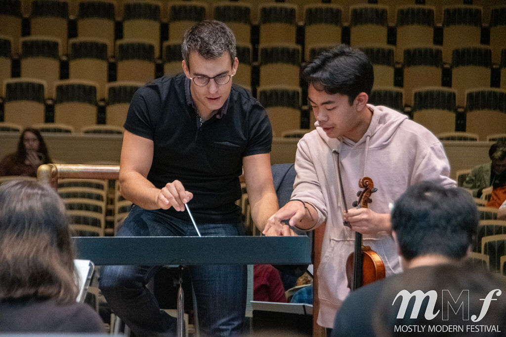 Conductor and student in the Mostly Modern Orchestra